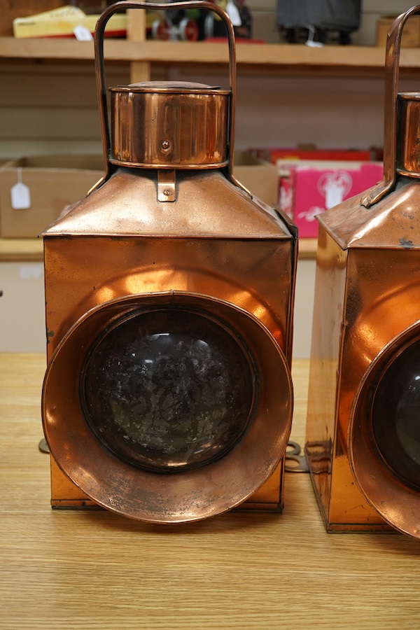 A pair of copper marine or railway oil lamps (missing burners and reservoirs), 44cm high. Condition - fair.